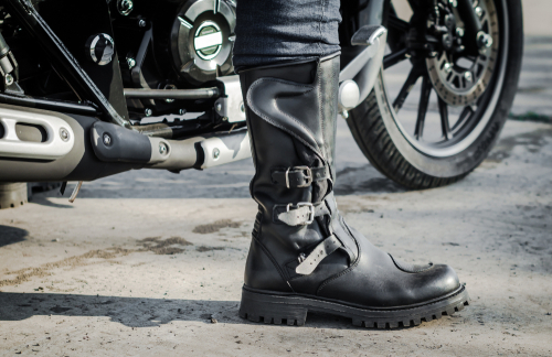 Biker,leg,in,a,boot,against,the,backdrop,of,a